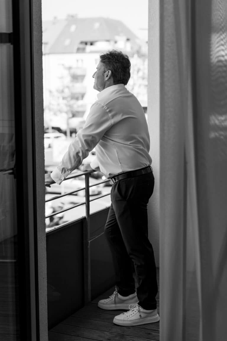 00017-florian-knusper-hochzeitsfotograf-wuerzburg-person-auf-balkon-Schlosshotel Steinburg Wuerzburg