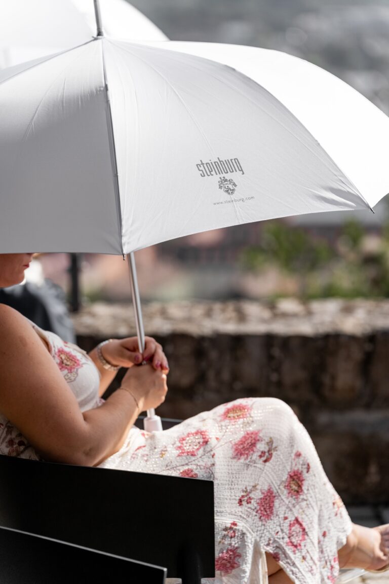 00083-florian-knusper-hochzeitsfotograf-wuerzburg-gast-mit-schirm-Schlosshotel Steinburg Wuerzburg