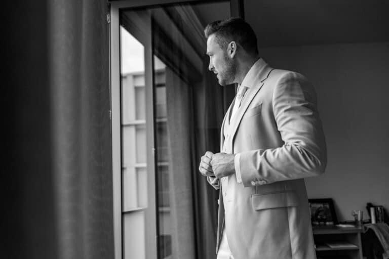 00270-2-florian-knusper-hochzeitsfotograf-wuerzburg-herr-im-anzug-am-fenster-Villa Oriental