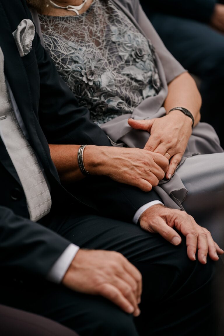 00397-florian-knusper-hochzeitsfotograf-wuerzburg-gaeste-halten-haendchen-Brückenbaron