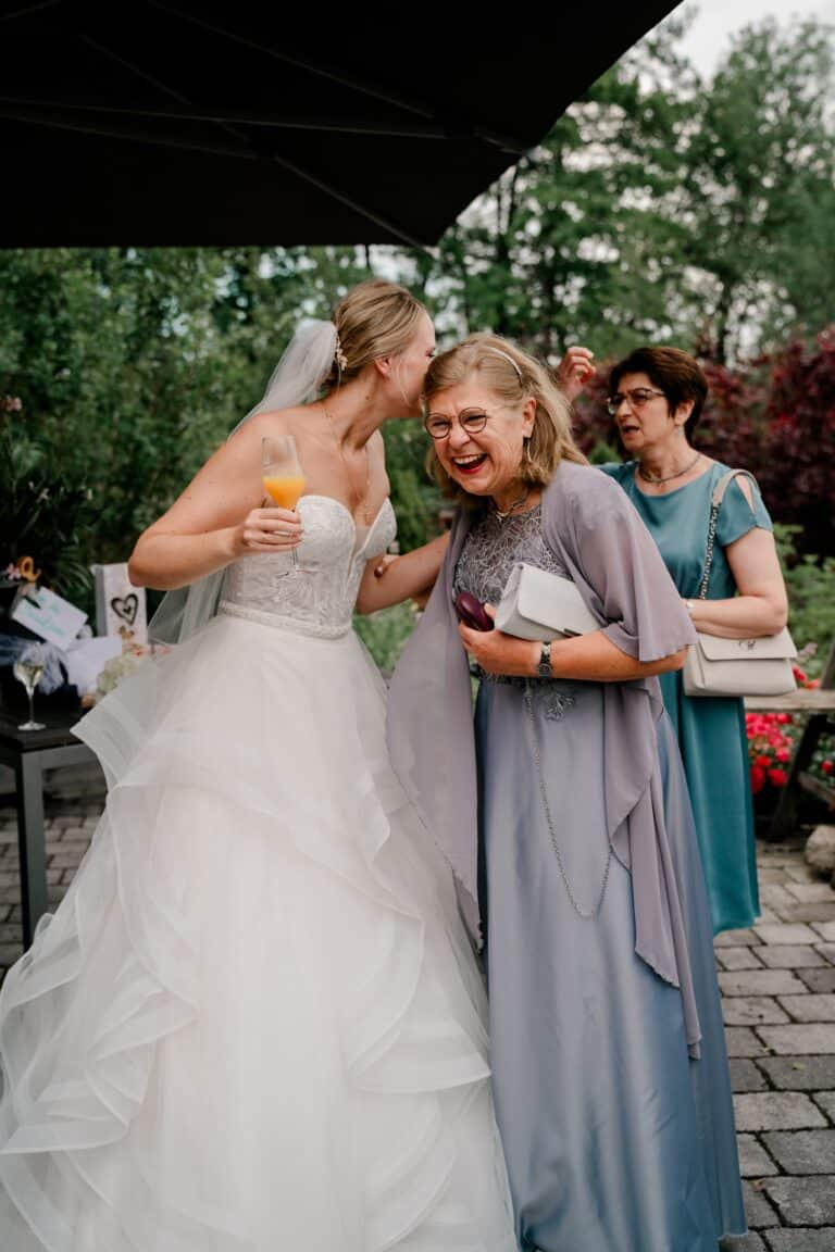 00459-florian-knusper-hochzeitsfotograf-wuerzburg-braut-mit-gaesten-im-garten-Brückenbaron