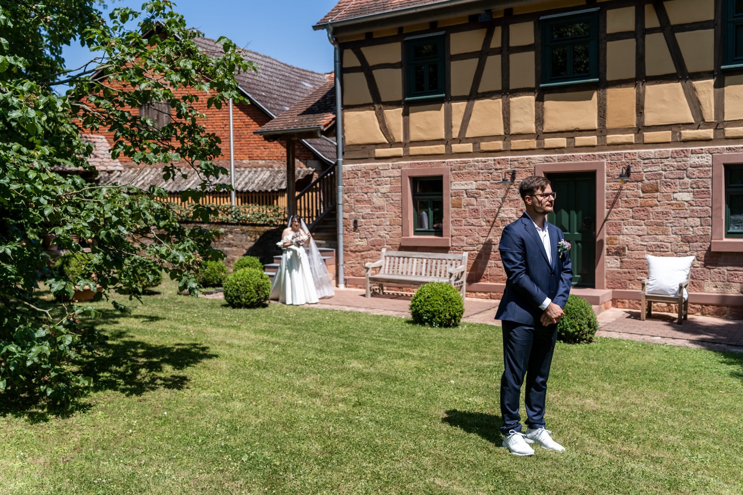 Gartenhochzeit mit Brautpaar vor Fachwerkhaus. Hofgut Hünersdorff