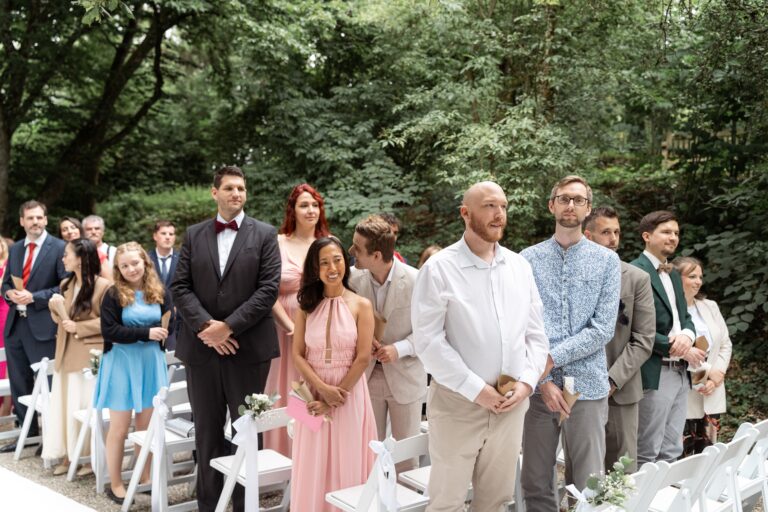 01040-florian-knusper-hochzeitsfotograf-wuerzburg-gruppe-von-gaesten-stehen-im-garten-villa-oriental