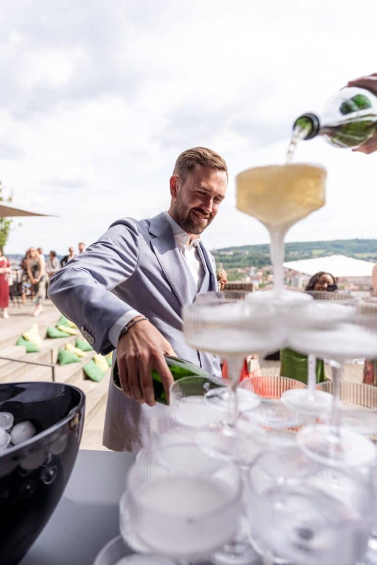 02332-florian-knusper-hochzeitsfotograf-wuerzburg-sekt-ausschenken-am-buffet-Schlosshotel Steinburg Wuerzburg