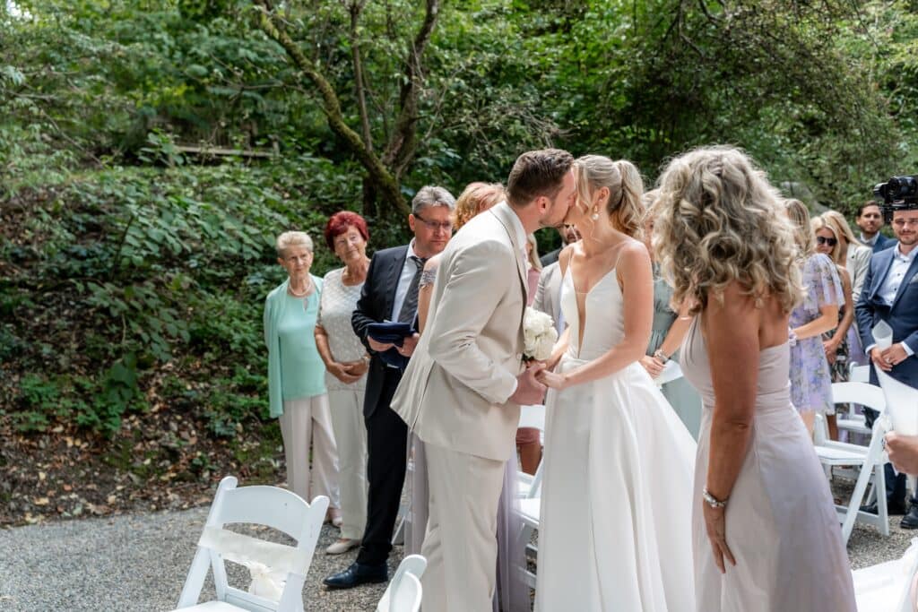 Hochzeitspaar küsst sich bei Trauung im Freien