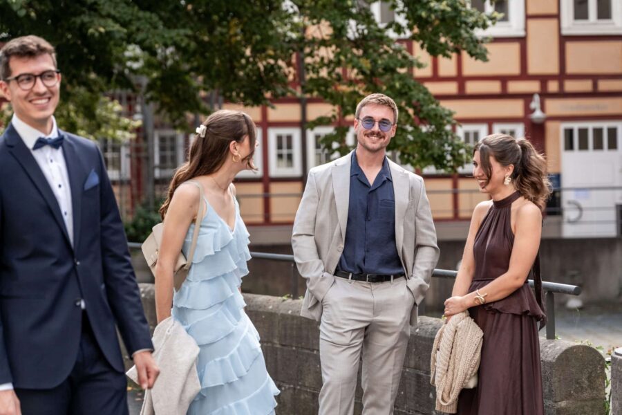 Hochzeitsgäste in eleganter Sommerkleidung draußen