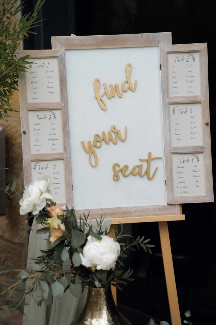 Tischordnung auf Staffelei mit Blumendeko