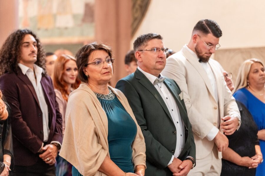 Gäste bei Hochzeitszeremonie in festlicher Kleidung