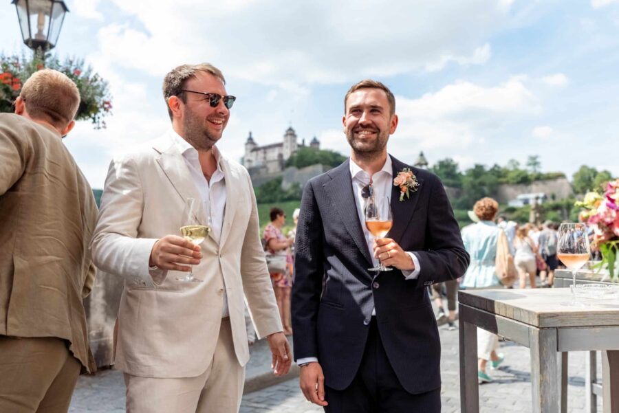 Gäste im Sommeranzug bei Hochzeitsfeier im Freien