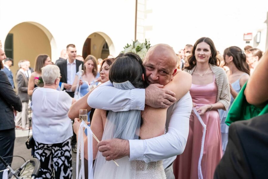 Hochzeitsgäste begrüßen das Brautpaar draußen