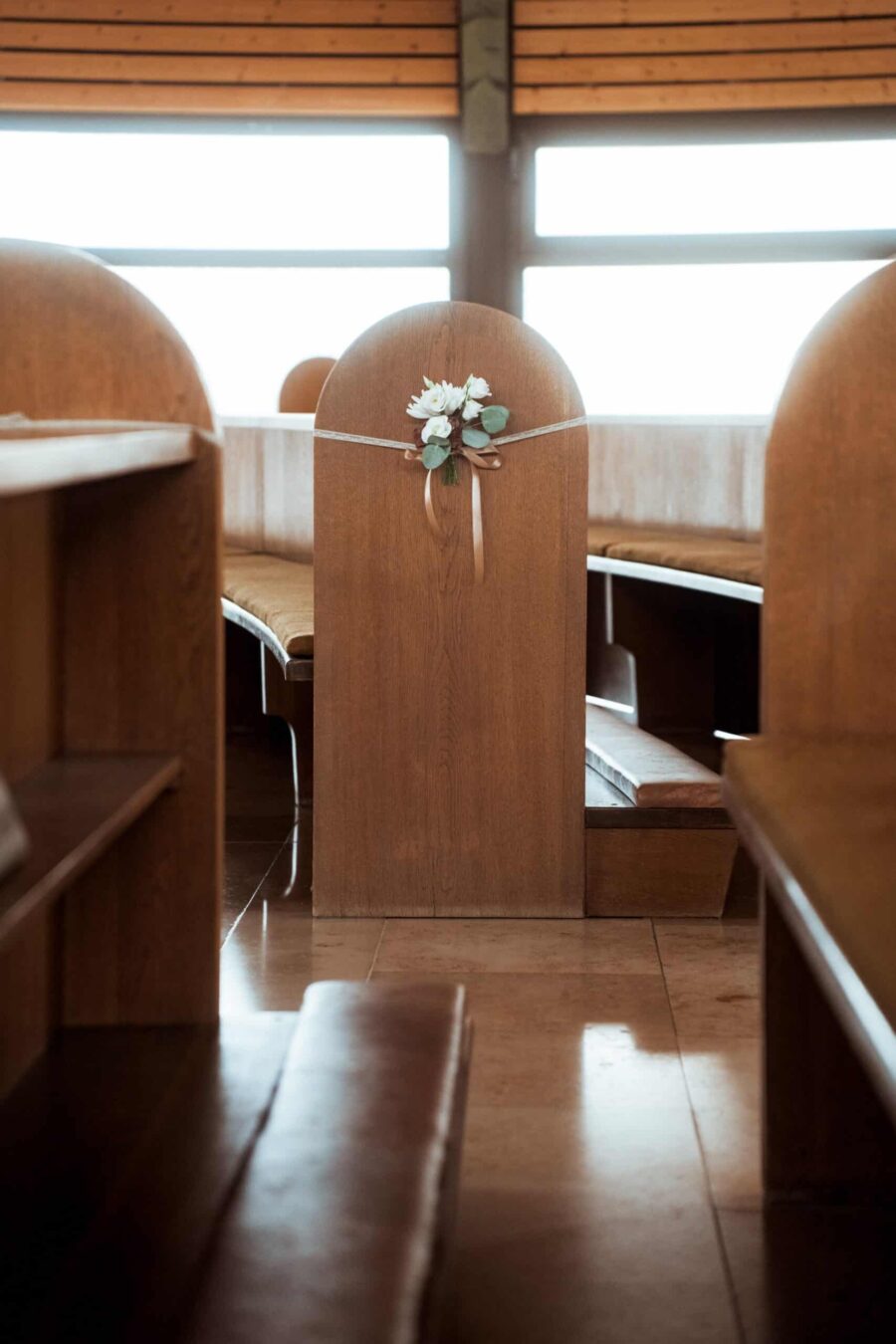 Kirchbank mit Blumendekoration für Hochzeit