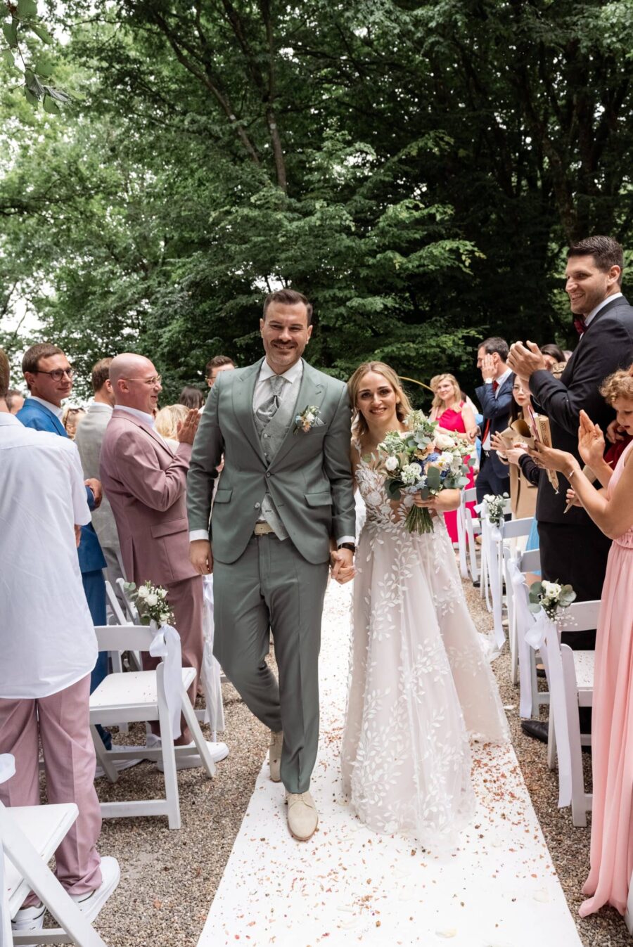 Brautpaar Hand in Hand im festlichen Garten