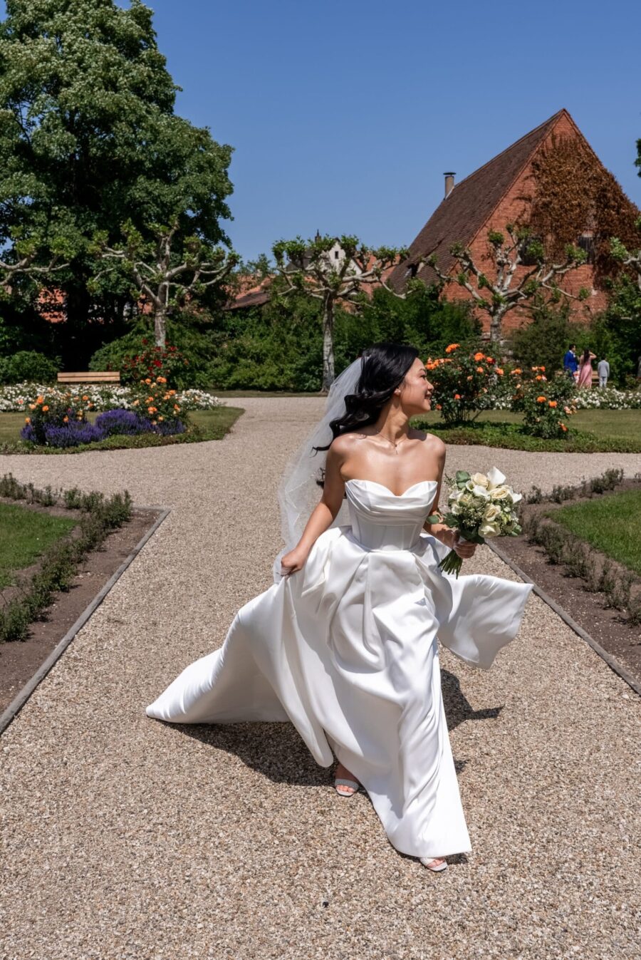 Braut im Garten mit Blumenstrauß, Hotel Schindlerhof