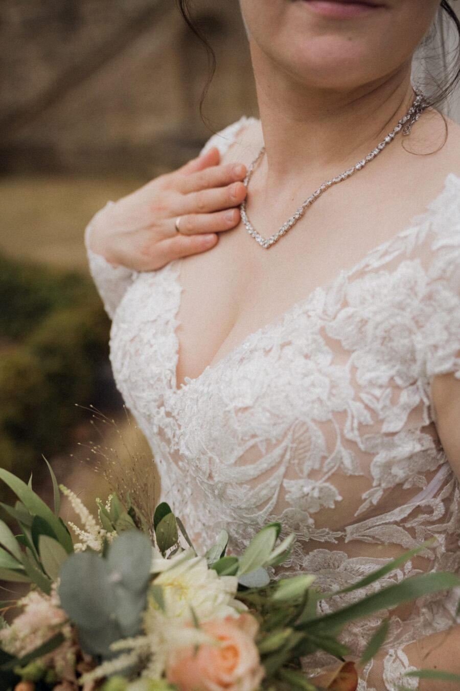 Braut mit Blumenstrauß und Spitzenkleid