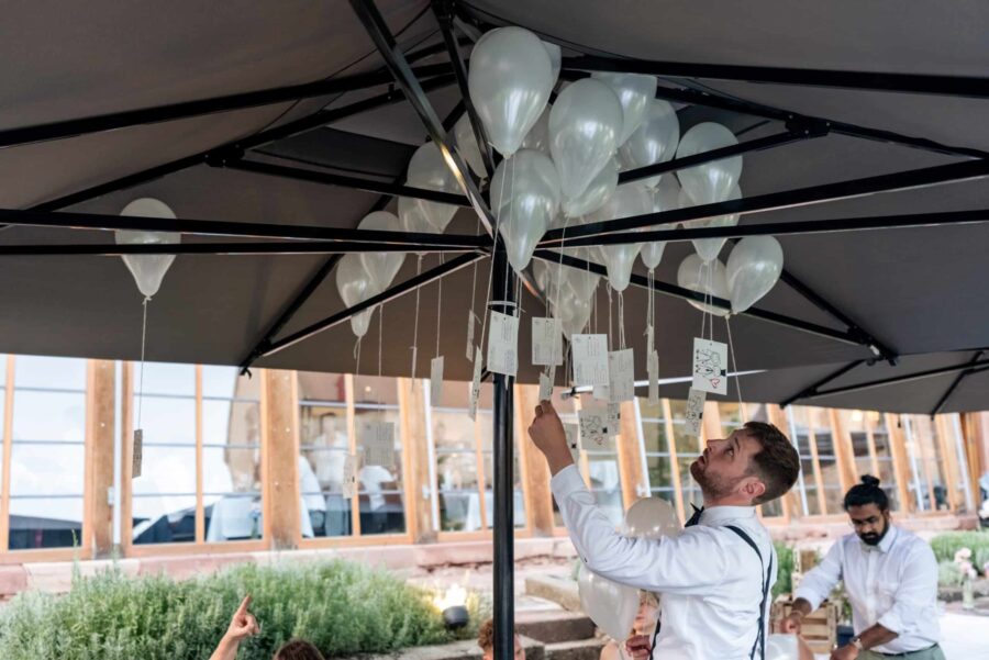 Hochzeitsballons unter Pavillon befestigen