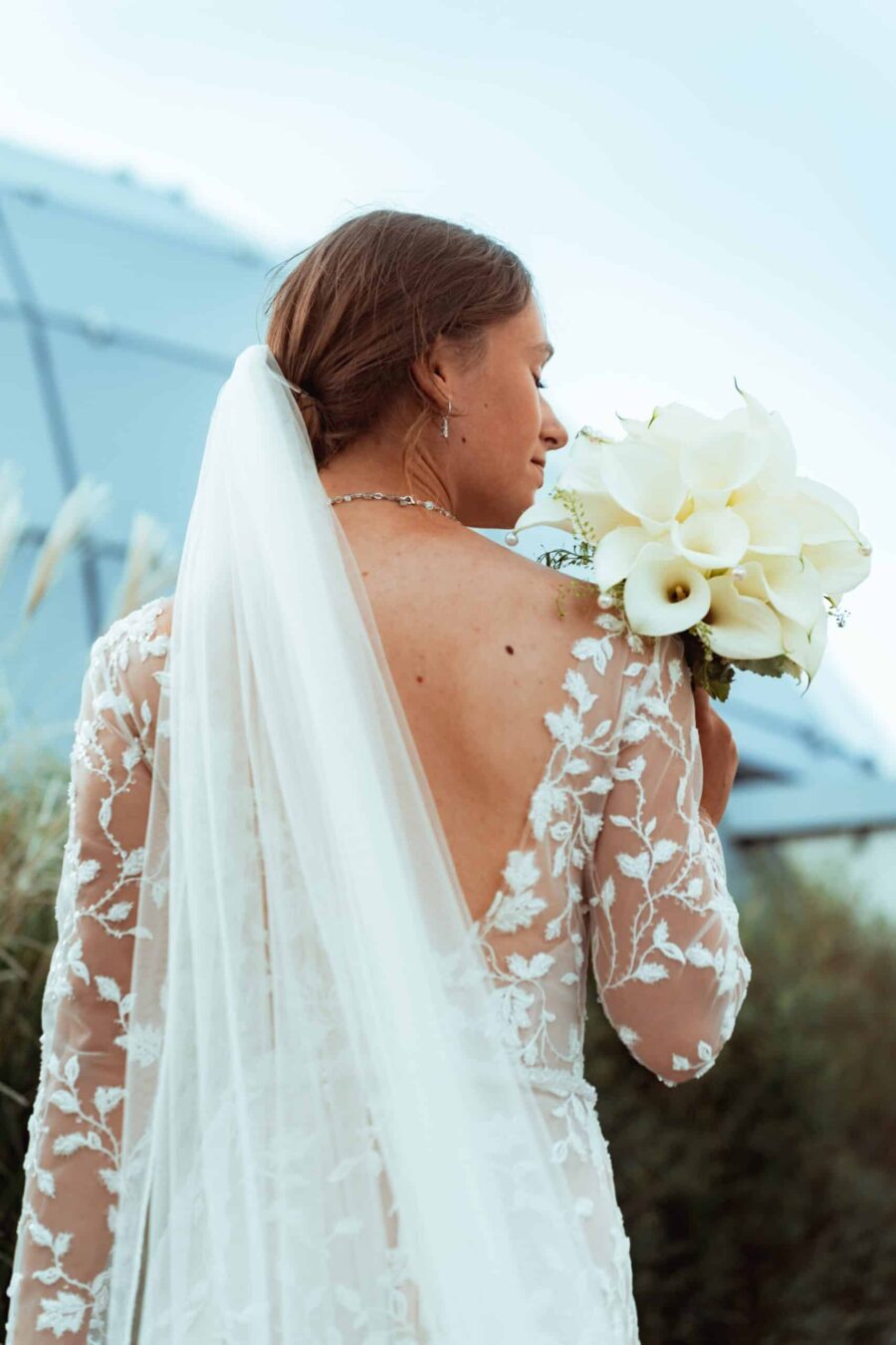 Braut mit Blumenstrauß und langem Schleier