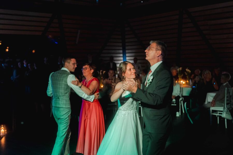 Tanzendes Brautpaar mit Gästen auf der Hochzeitsfeier.