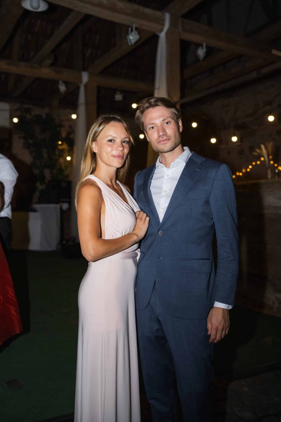 Gäste posieren im festlich beleuchteten Saal.