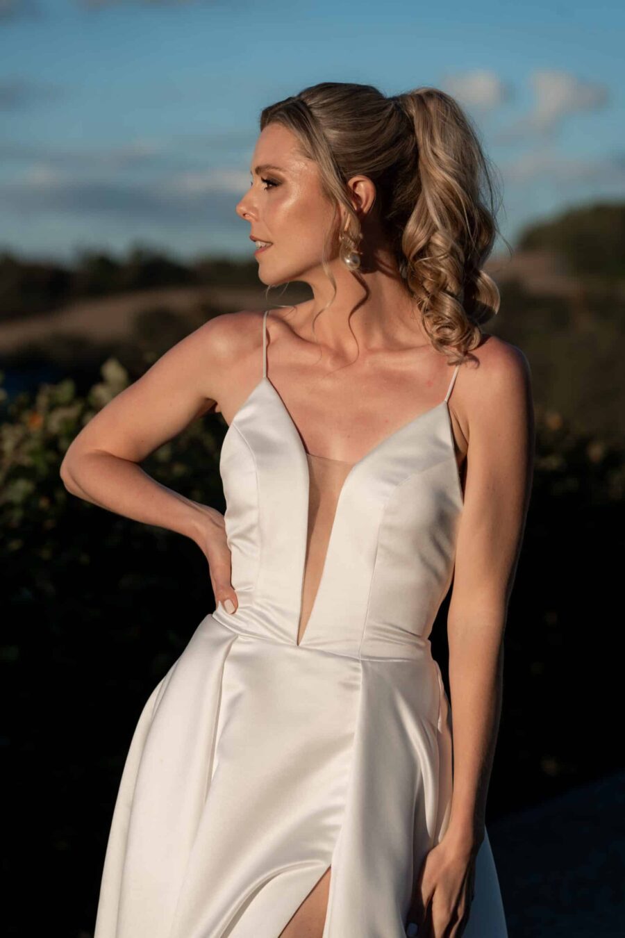 Braut in elegantem Hochzeitskleid im Freien